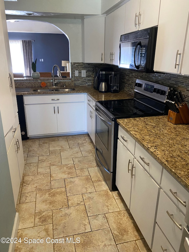 kitchen featuring stainless steel electric range, sink, decorative backsplash, and white cabinets