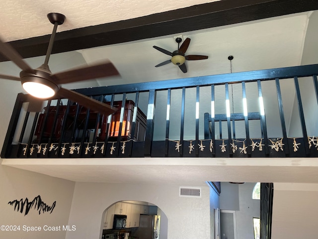 stairs with ceiling fan and beam ceiling