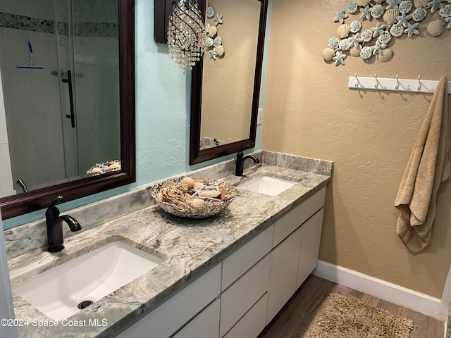 bathroom with vanity, hardwood / wood-style floors, and an enclosed shower