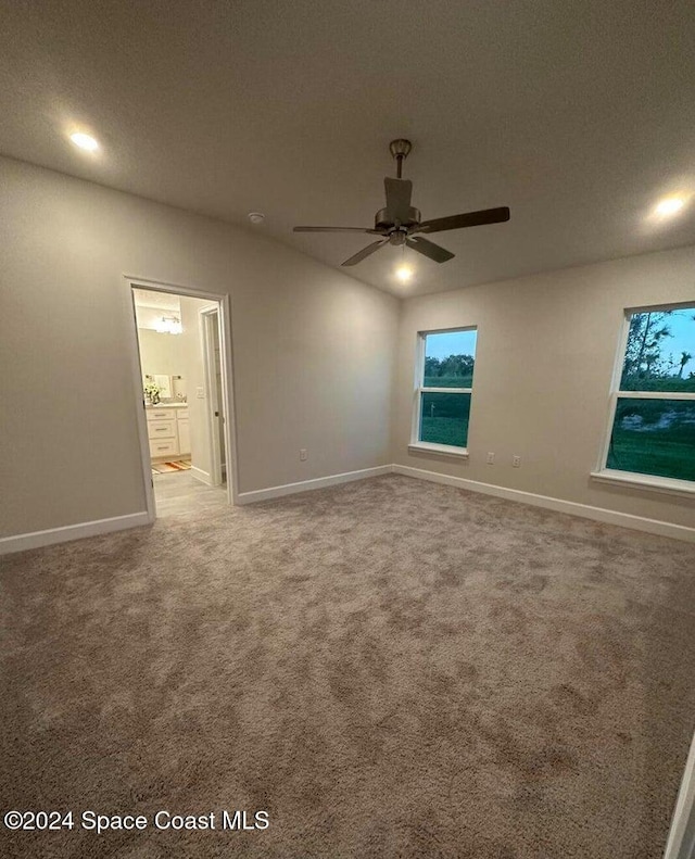 unfurnished room with a textured ceiling, carpet flooring, and ceiling fan