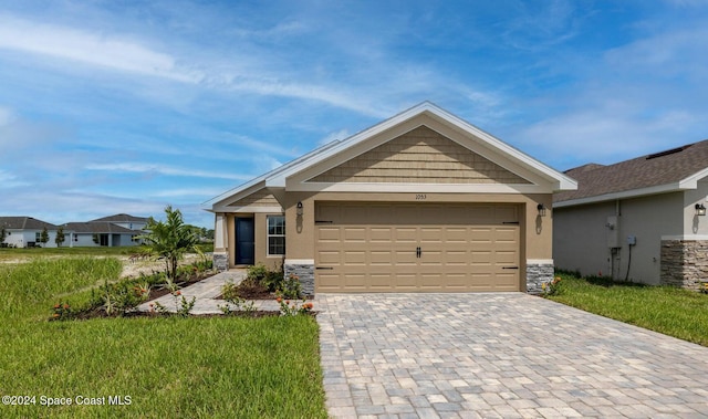 view of front of house featuring a garage and a front lawn