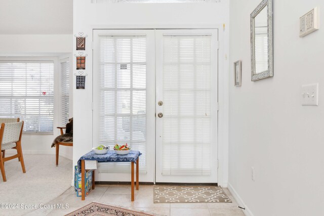 doorway to outside featuring light tile patterned floors and plenty of natural light