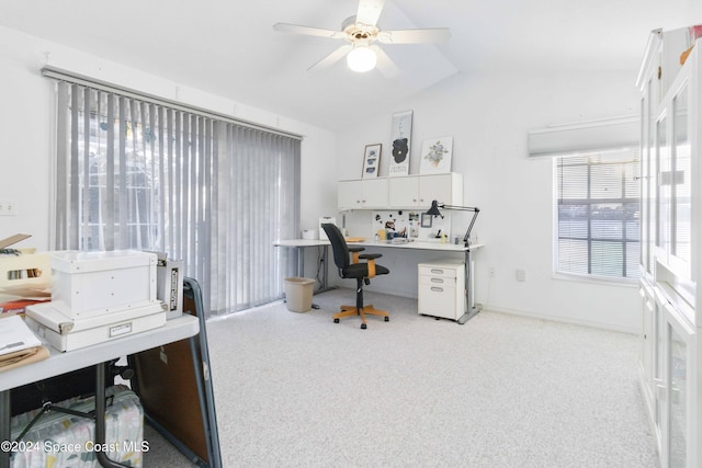 carpeted office space featuring lofted ceiling and ceiling fan