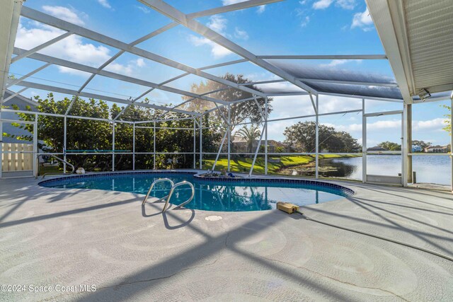 view of swimming pool featuring a water view, a patio, and glass enclosure