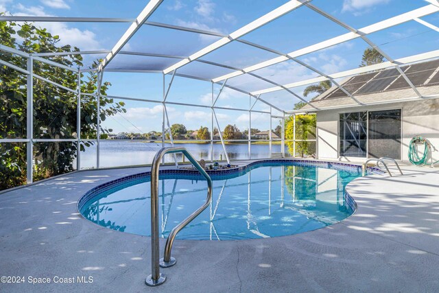 view of swimming pool featuring a water view, a patio, glass enclosure, and a hot tub