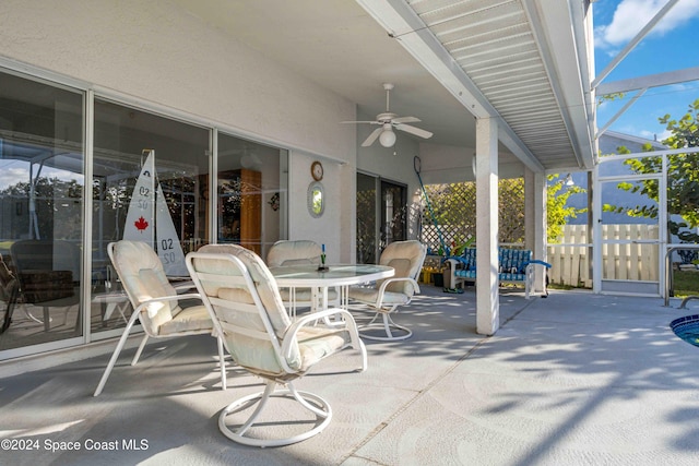 view of patio / terrace featuring ceiling fan and a lanai