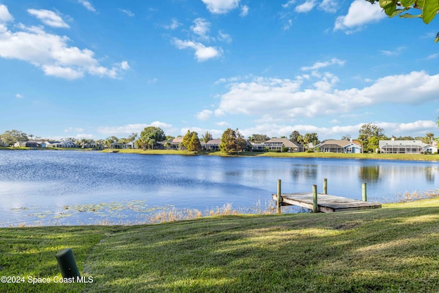 dock area with a water view and a lawn