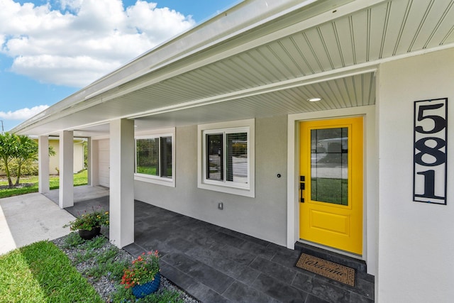 view of exterior entry with a porch