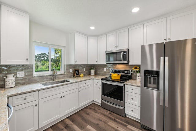 kitchen featuring sink, appliances with stainless steel finishes, and white cabinets