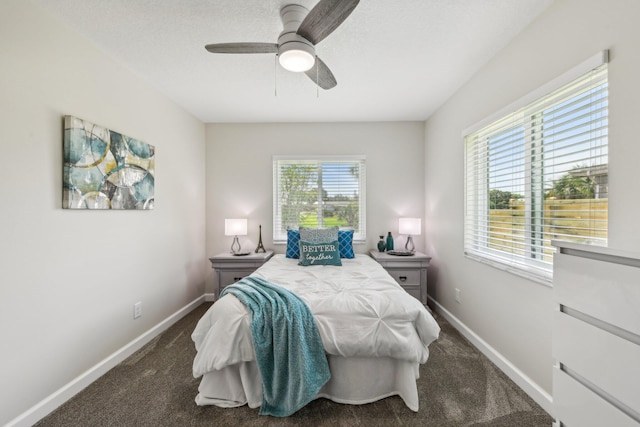 bedroom featuring dark colored carpet and ceiling fan