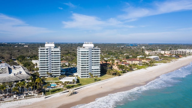 bird's eye view featuring a water view and a beach view