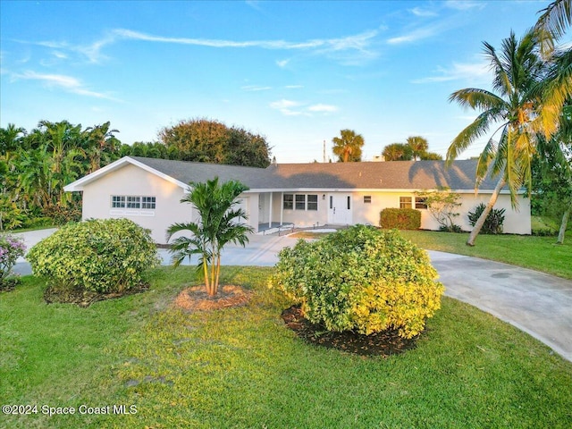 ranch-style home featuring a front yard