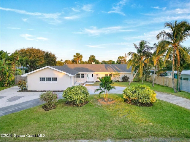 single story home featuring a front yard and a garage