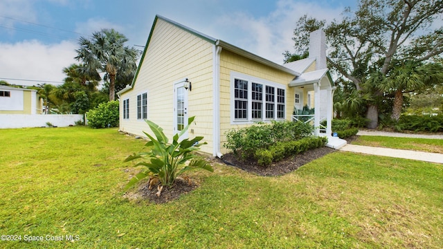 view of side of property with a yard