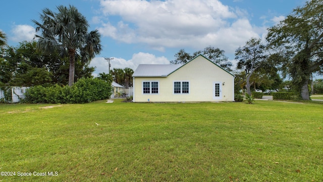 back of property with a yard