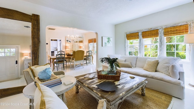 living room with a textured ceiling and a chandelier