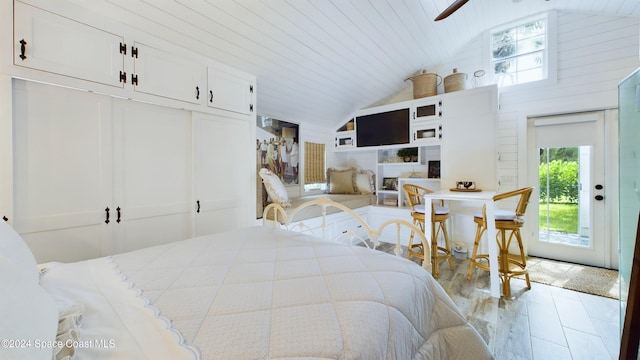 bedroom with multiple windows, a closet, and vaulted ceiling