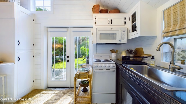 kitchen with french doors, backsplash, sink, white cabinets, and white appliances