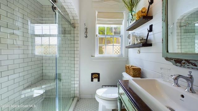 bathroom with vanity, walk in shower, tile patterned flooring, and toilet