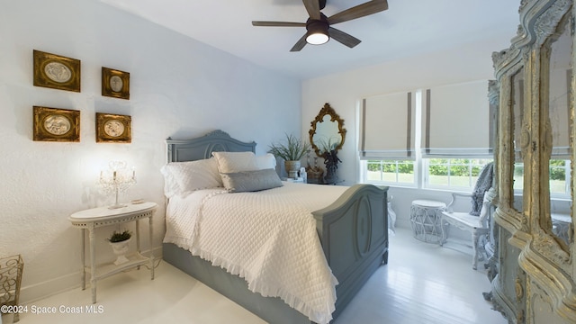 bedroom with light hardwood / wood-style floors and ceiling fan