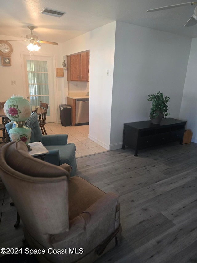 living room with light hardwood / wood-style flooring and ceiling fan