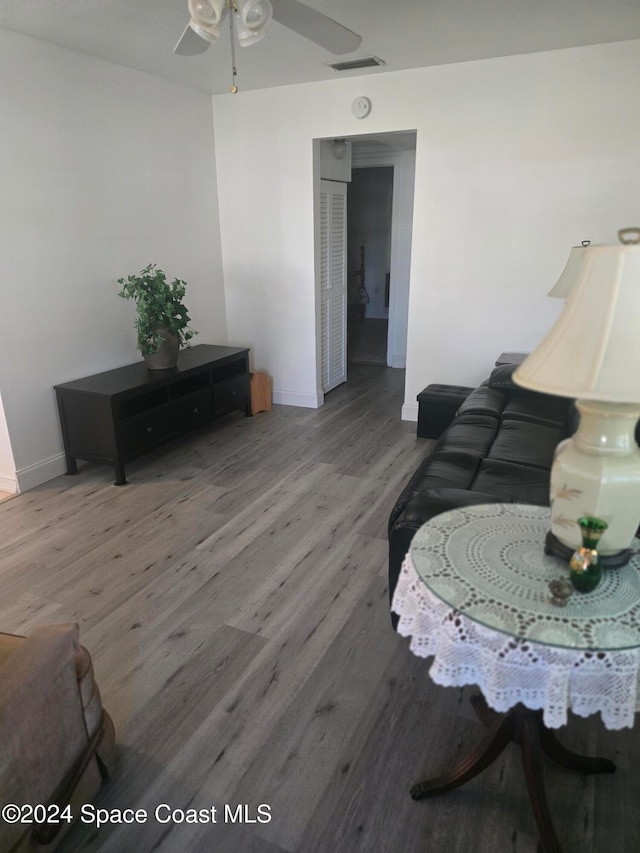 living room with hardwood / wood-style flooring and ceiling fan