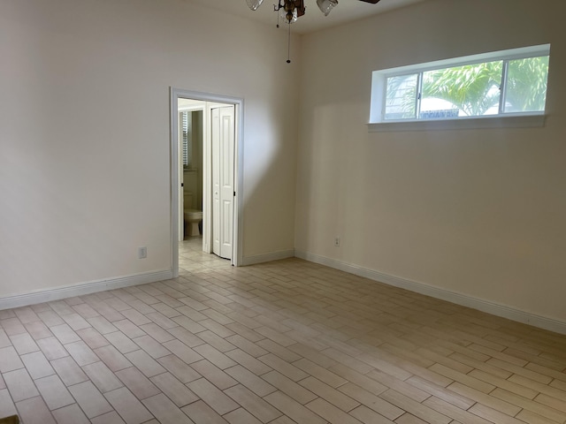 spare room with light wood-type flooring and ceiling fan