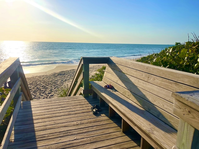 surrounding community featuring a water view and a view of the beach