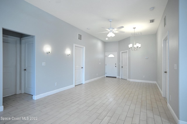 unfurnished room featuring ceiling fan with notable chandelier