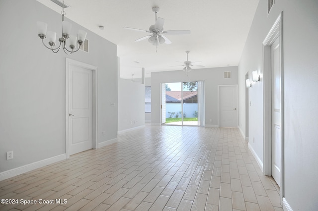 spare room featuring light hardwood / wood-style flooring and ceiling fan with notable chandelier