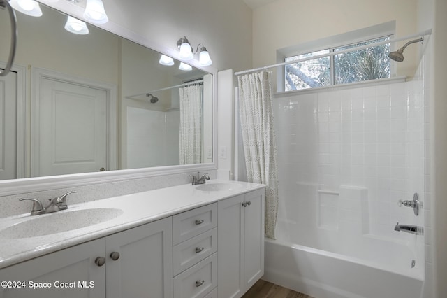 bathroom featuring vanity, shower / bathtub combination with curtain, and hardwood / wood-style floors