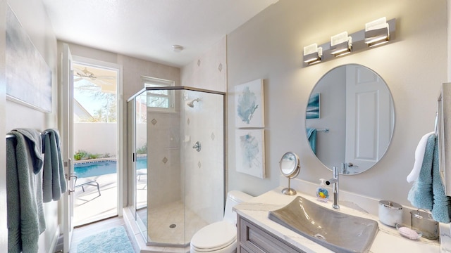 bathroom featuring an enclosed shower, vanity, and toilet