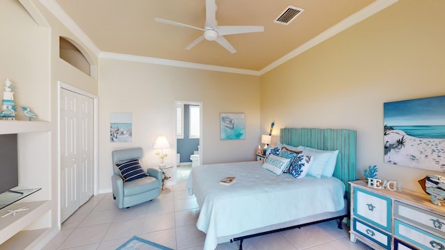 bedroom with ceiling fan, a closet, light tile patterned floors, and ornamental molding