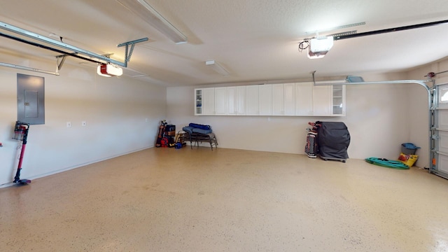 garage featuring a garage door opener and electric panel