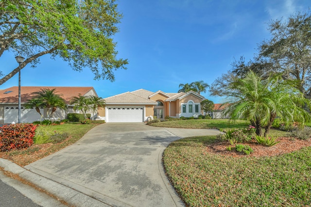 ranch-style house with a garage and a front lawn