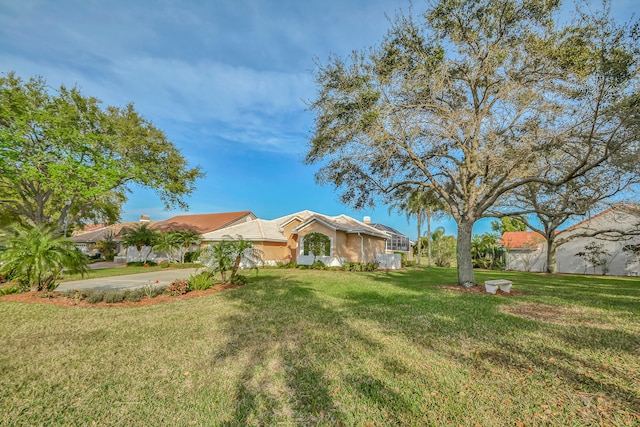 ranch-style home featuring a front yard