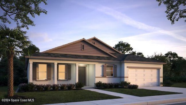 view of front of house with a yard and a garage