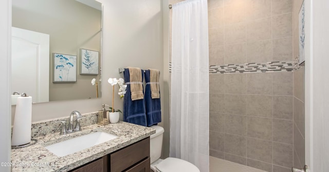 bathroom featuring toilet, vanity, and a shower with shower curtain