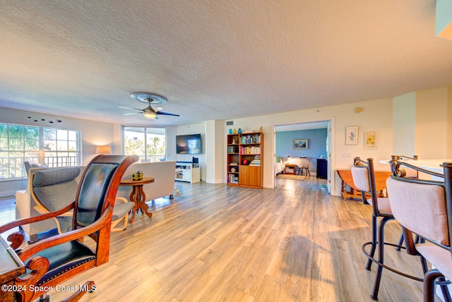 office space with light hardwood / wood-style flooring, a textured ceiling, and ceiling fan