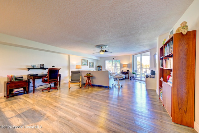 office with ceiling fan, hardwood / wood-style flooring, and a textured ceiling