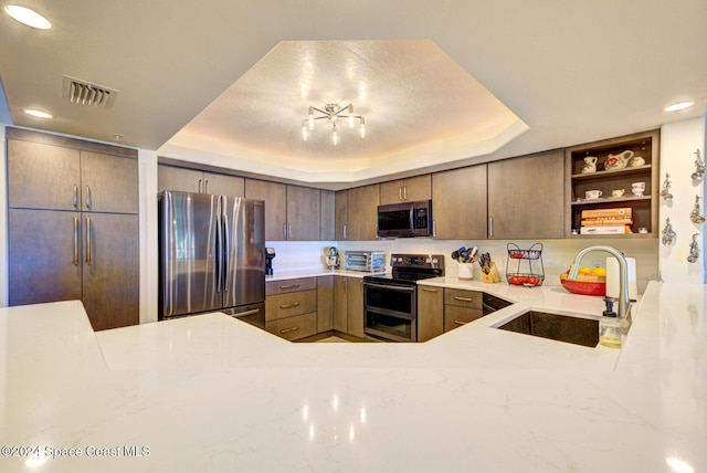 3360 S Atlantic Ave Unit 212, Cocoa Beach, FL 32931 - kitchen with appliances with stainless steel finishes, a sink, open shelves, a raised ceiling, and light stone countertops