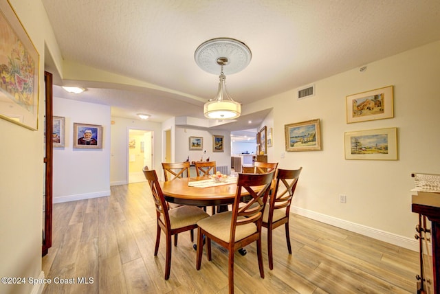 3360 S Atlantic Ave Unit 212, Cocoa Beach, FL 32931 - dining area with light wood-style flooring and baseboards