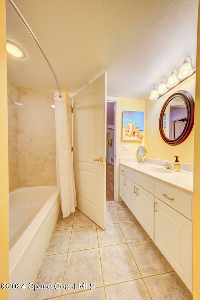 bathroom featuring vanity, a textured ceiling, shower / tub combo with curtain, and tile patterned floors