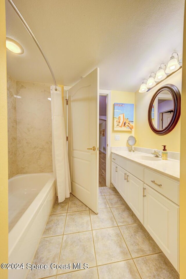 3360 S Atlantic Ave Unit 212, Cocoa Beach, FL 32931 - full bathroom featuring tile patterned floors, vanity, shower / bath combo with shower curtain, and a textured ceiling
