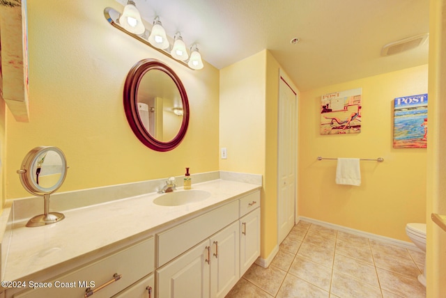 bathroom featuring vanity, toilet, and tile patterned floors