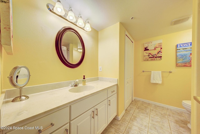 3360 S Atlantic Ave Unit 212, Cocoa Beach, FL 32931 - bathroom with tile patterned flooring, vanity, toilet, and baseboards