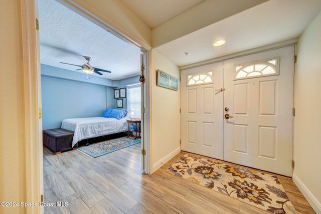 entrance foyer featuring light hardwood / wood-style flooring and ceiling fan