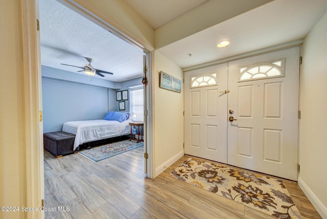 3360 S Atlantic Ave Unit 212, Cocoa Beach, FL 32931 - foyer featuring light wood-style floors, baseboards, a ceiling fan, and recessed lighting