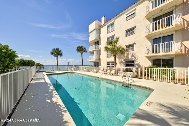 3360 S Atlantic Ave Unit 212, Cocoa Beach, FL 32931 - community pool featuring fence and a patio