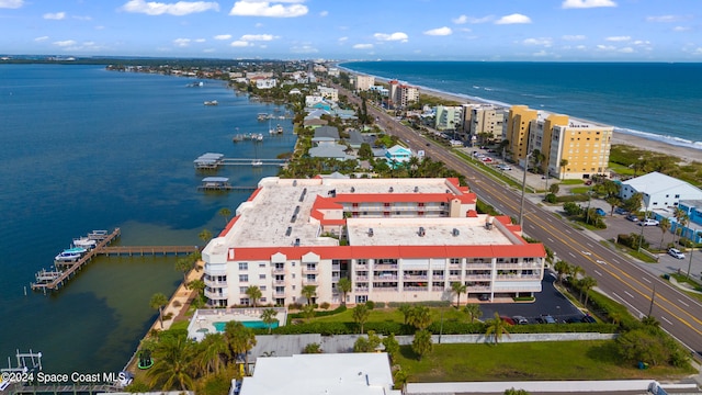 birds eye view of property with a water view and a beach view